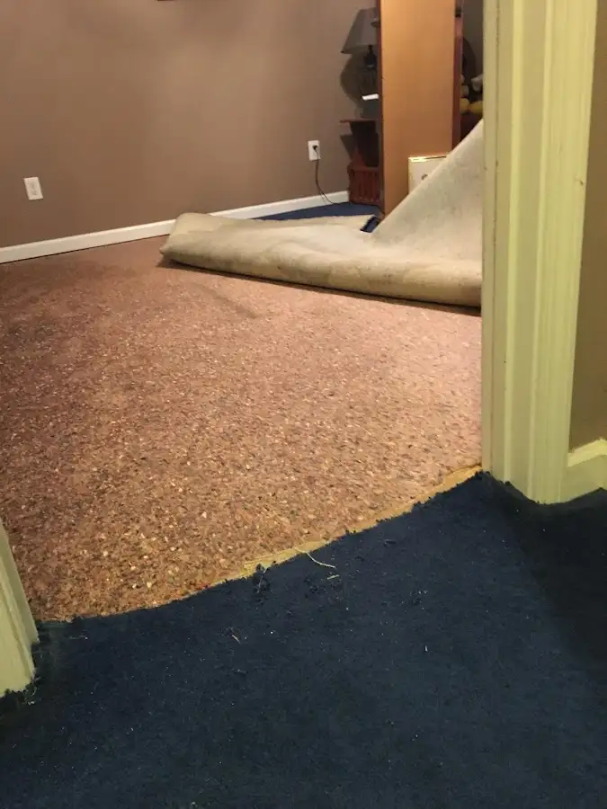 Carpet pad removal revealing water damage during Water Mitigation Services in Las Vegas